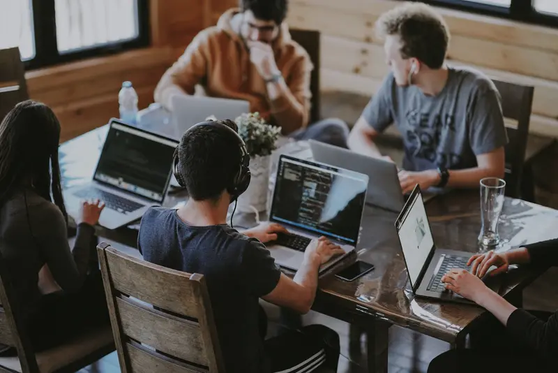 A development team working together on laptops
