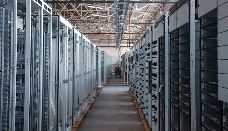 A long aisle of server racks in a data center
